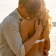 Caring and beautiful romantic couple in embrace at the beach - PhotoDune Item for Sale