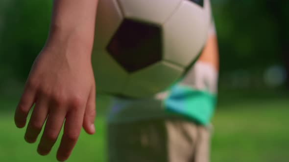 Unknown Boy Hand Holding Soccerball Closeup alt