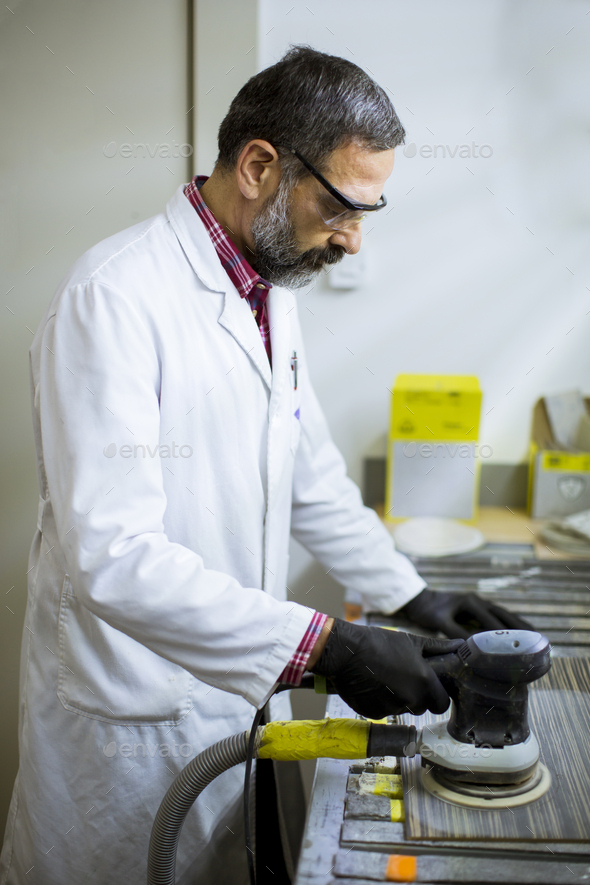 View at engineer in the laboratory examines ceramic tiles Stock Photo
