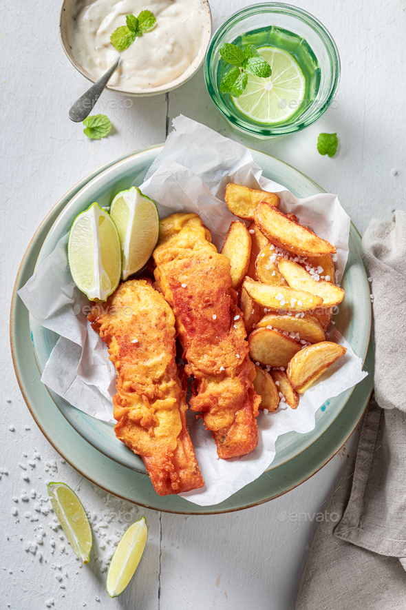 Grilled fish and chips with sauces and lime. Stock Photo by Shaiith