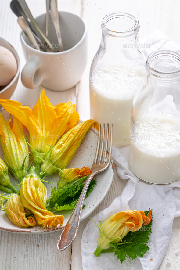 Preparation for fried zucchini flower made of pancake batter. Stock