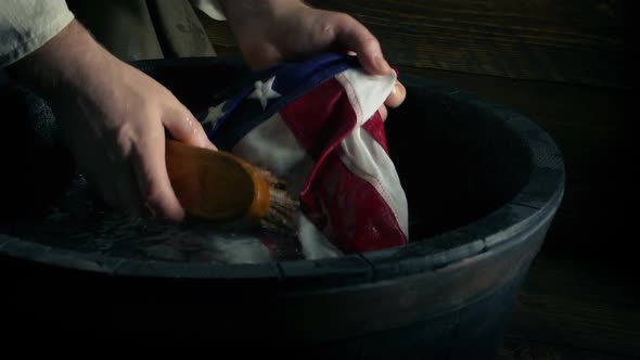 Hand Scrubbing American Flag History Scene alt