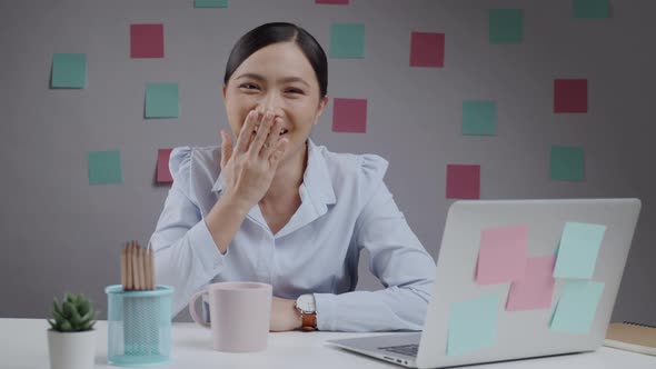 Asian woman happy working smilling and looking at camera.