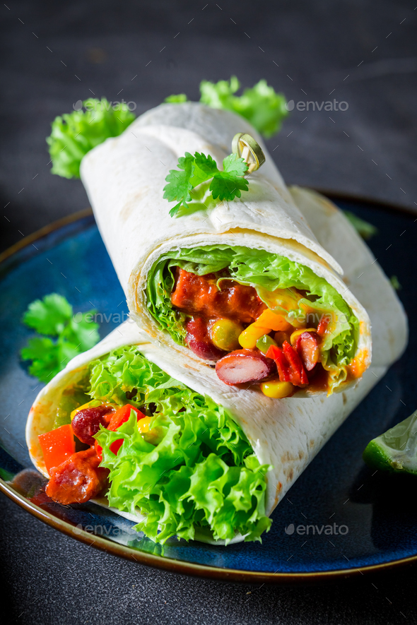 Burrito made of lettuce and vegetables with red salsa