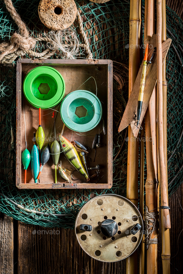 Vintage equipment for fishing with flies, floats and rods Stock Photo by  Shaiith