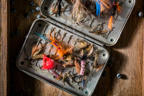 Vintage equipment for fishing with flies, floats and rods Stock Photo by  Shaiith