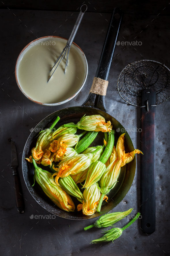 Ingredients for tasty fried zucchini flower made of pancake batter Stock Photo by Shaiith