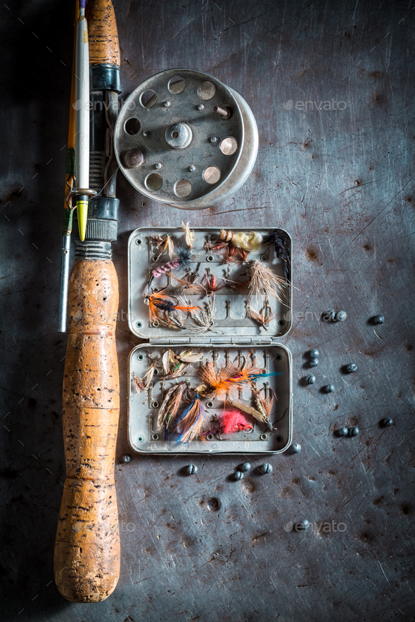 Vintage fishing tackle with flies, floats and rods Stock Photo by