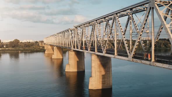 Aerial Drone Flight Across Railway Bridge and River