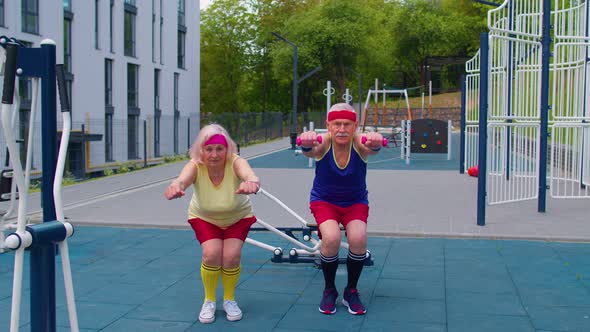 Senior Man Woman Doing Active Training Stretching Muscles Squatting Fitness Exercising on Playground alt