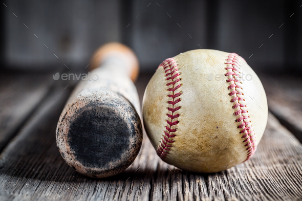 Old baseball bat and Ball on old wooden table