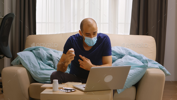 Man wearing mask on a video call with his doctor