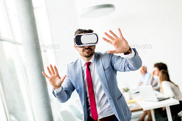 Modern businessman with virtual reality headset in the office - Stock Photo - Images