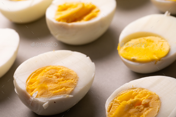 High angle view of fresh white boiled eggs with yellow yolks on table
