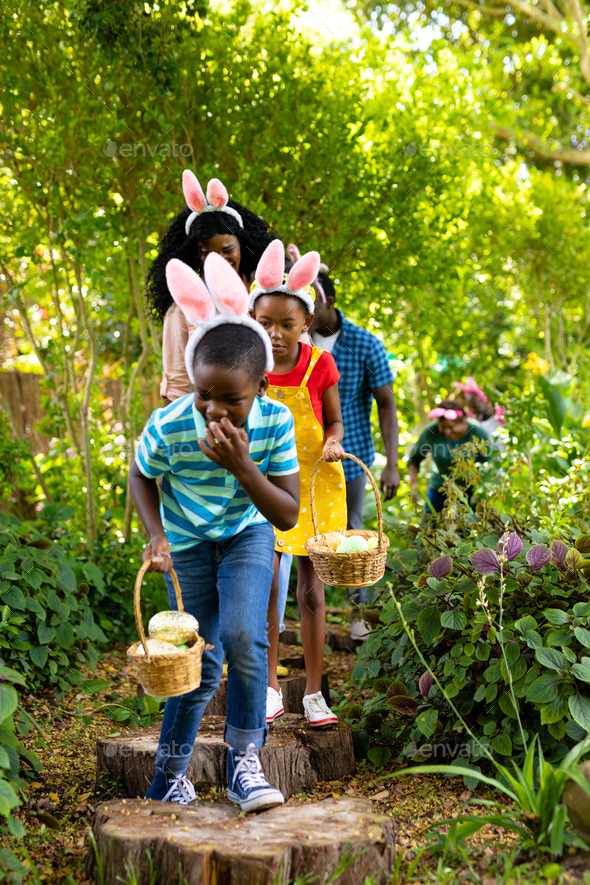 African american multigenerational family with baskets hiding easter