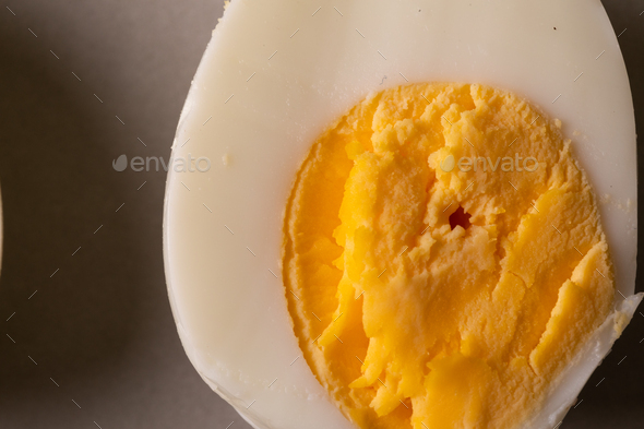Directly above close-up view of fresh boiled white egg with yellow yolk