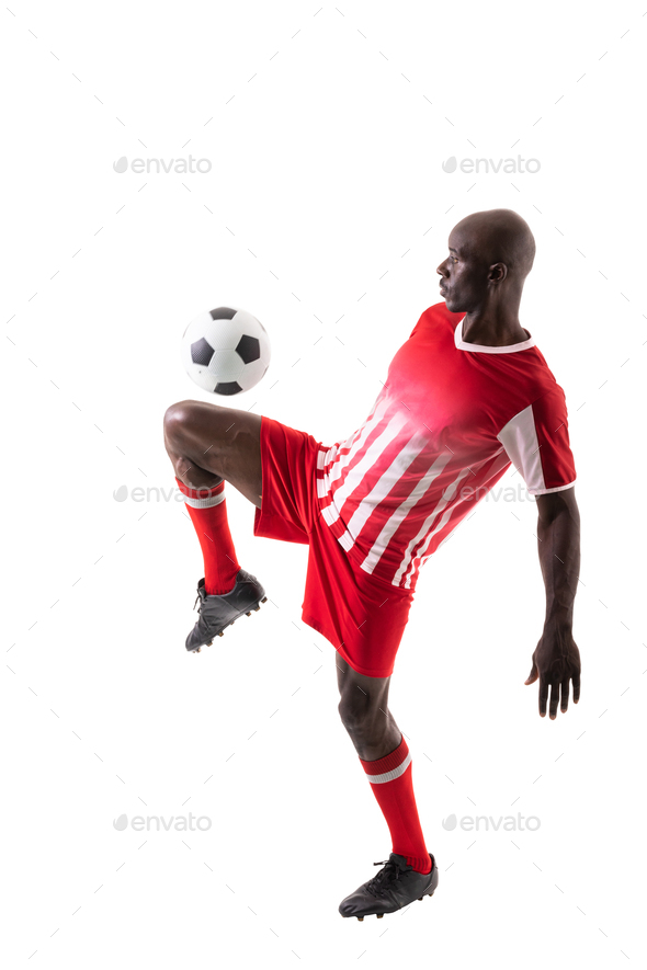 Skilled male african american soccer player kicking ball over white background