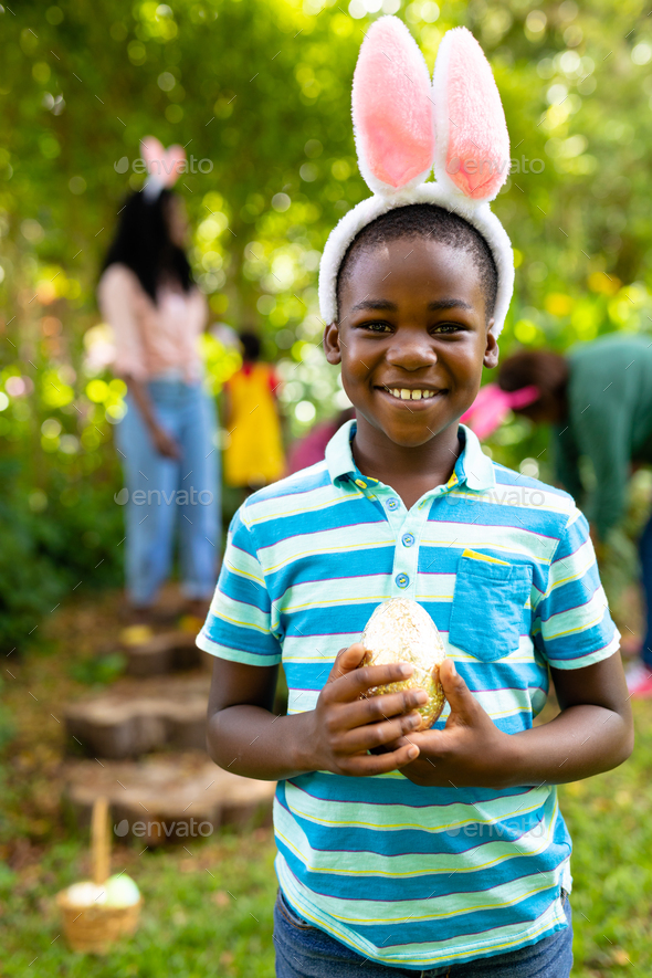 Free Photo  African American man in bunny ears holding Easter egg