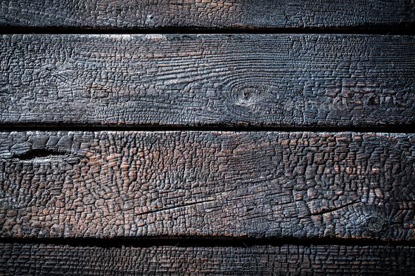 Closeup of burnt wooden fence as background