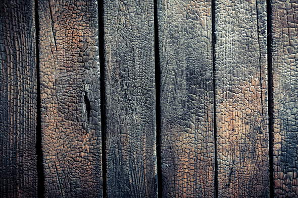 Closeup of black burnt wooden fence as background