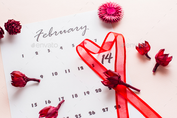 Valentine\'s Day. A red heart-shaped ribbon highlights the date February 14 on a calendar sheet