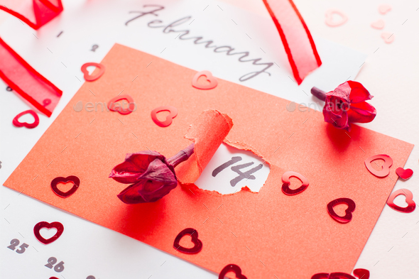 The date February 14 is highlighted with a hole in red cardboard, dried flowers and a ribbon