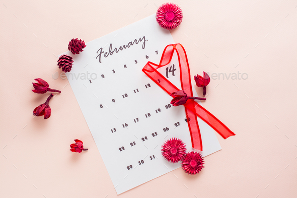 A red heart-shaped ribbon highlights the date February 14 on a calendar sheet