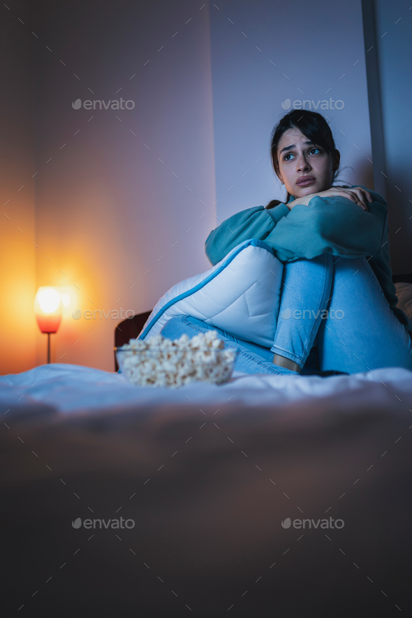 Woman watching sad movie on TV