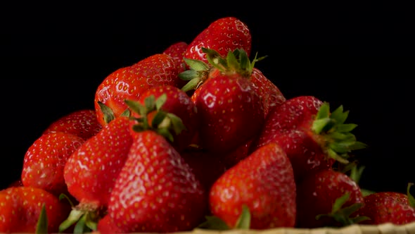 Fresh tasty strawberries in close up in the basket turns on plate
