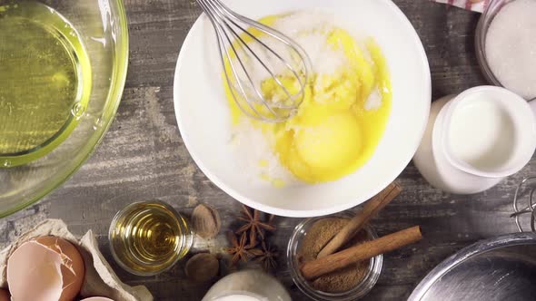 Pour the Sugar Into a Bowl with Egg Yolk Top View