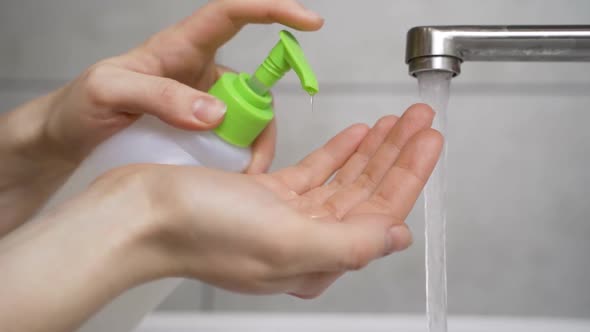 Woman Disinfects Her Hands with a Sanitizer. Observe Good Hygiene During the Epidemic alt