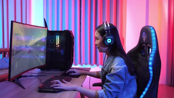 Excited Girl Playing Car Race Game On A Computer alt