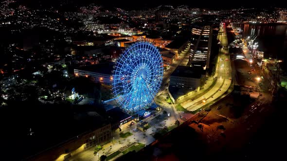 Night panoramic landscape of illuminated ferris wheel at Rio de Janeiro Brazil alt