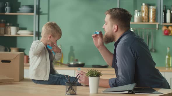 Young Father With Adorable Son Spent Time Together at Home alt