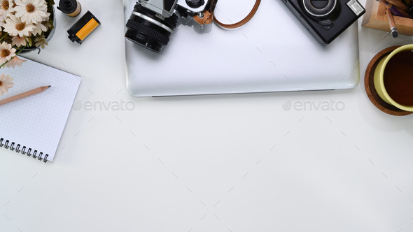 Above view of photographer workplace with laptop, notebook, camera, accessories. - Stock Photo - Images
