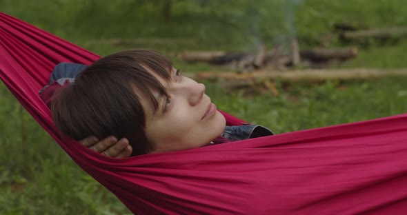 Crop Zooming Shot of Young Woman Having Rest Napping in Hammock in Summer Green Forest alt