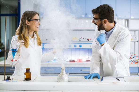 Researchers doing experiment with smoke on a table of a chemical ...