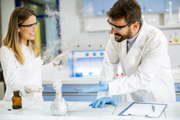 Researchers doing experiment with smoke on a table of a chemical ...