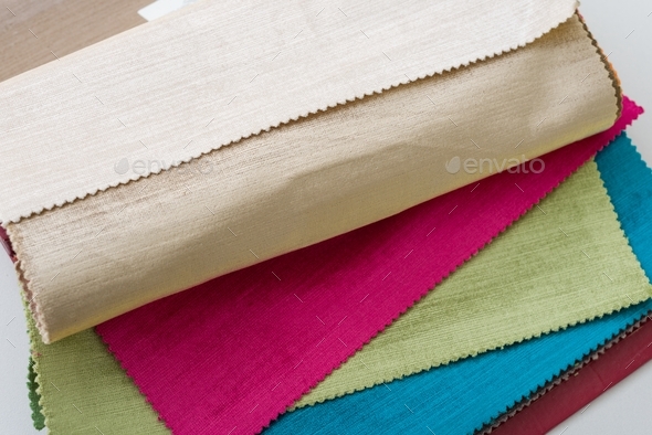 Samples of colorful interior fabrics. Book of fabrics for curtains, upholstery