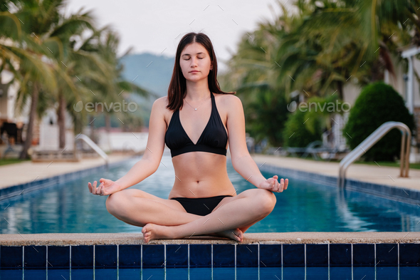 young pretty woman in black bra sitting on bed. morning time Stock Photo