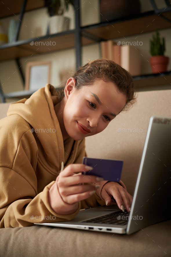 Woman Entering Information From Credit Card