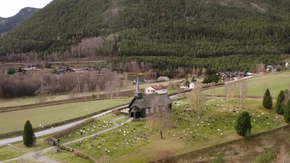 Panoramic View On Idyllic Landscape With A Wooden Church In Sel, Norway - aerial drone shot alt