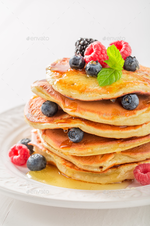 Sweet american pancakes with blueberries and raspberries Stock Photo by  Shaiith