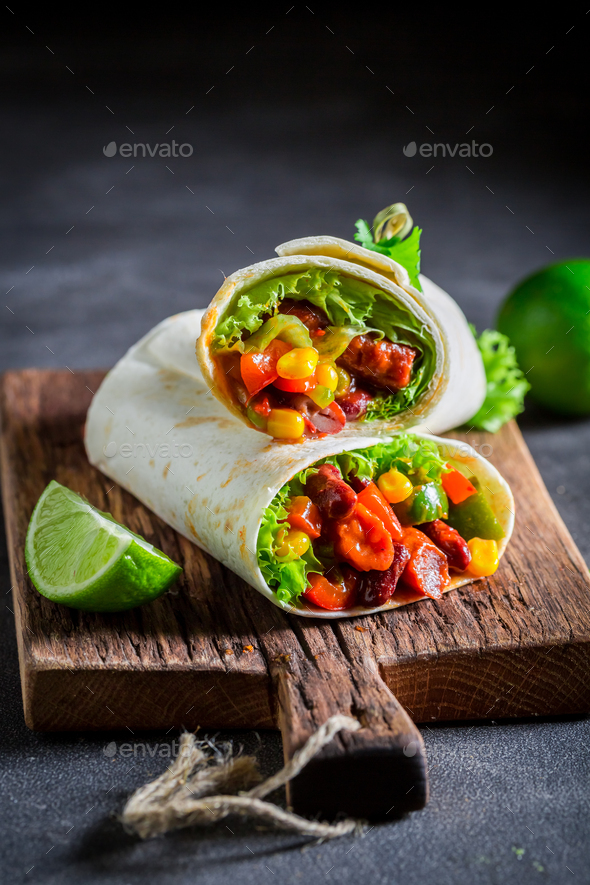 Spicy burrito with red salsa, lettuce and vegetables
