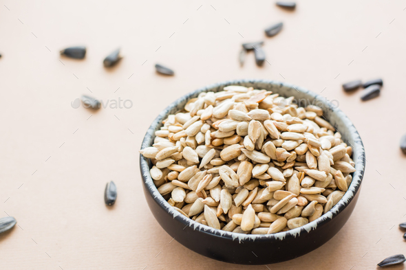Raw peeled sunflower seeds in a bowl on the table. Natural source of vitamins and fat. Copy space
