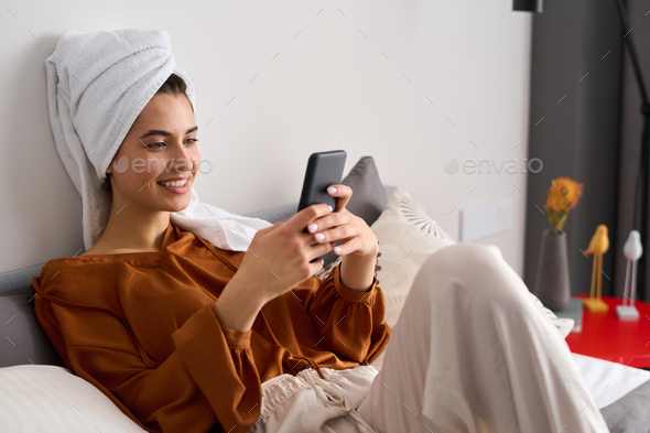 Happy young woman communicating in video chat in smartphone