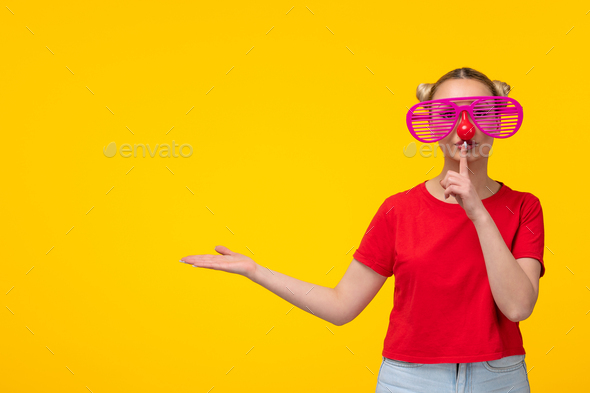 caucasian woman with funny sunglasses asking to be silent yellow background girl cartoon