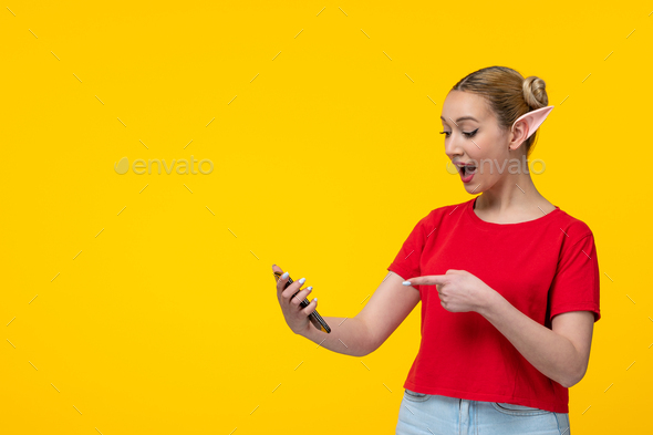 caucasian female in red t-shirt with elf ears using her phone yellow background girl cartoon