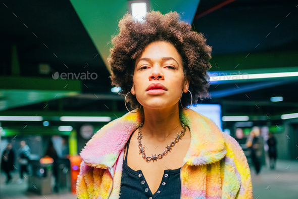 Portrait young black woman indoor underground station looking camera serious
