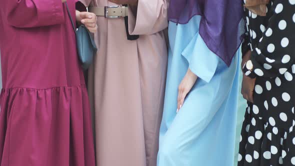 Group of Multiracial Muslim Businesswoman Chatting, Checking Newsfeed on Smartphone While Having alt